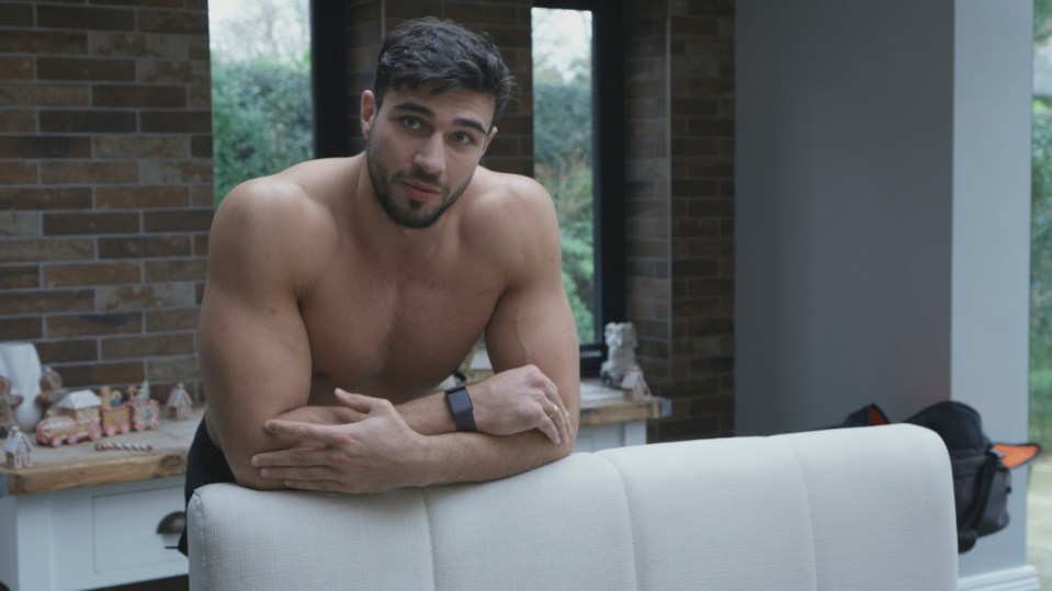 Tommy Fury shirtless in his kitchen.