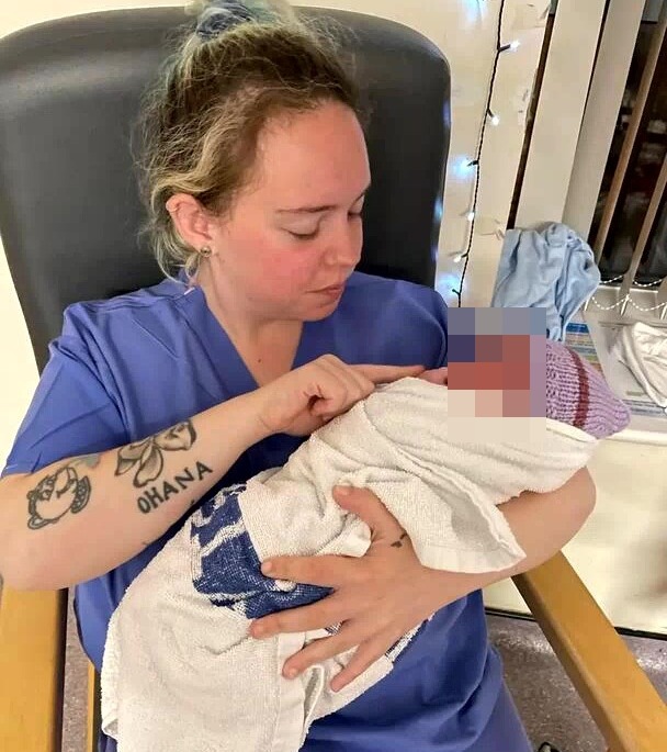 Woman holding a newborn baby.