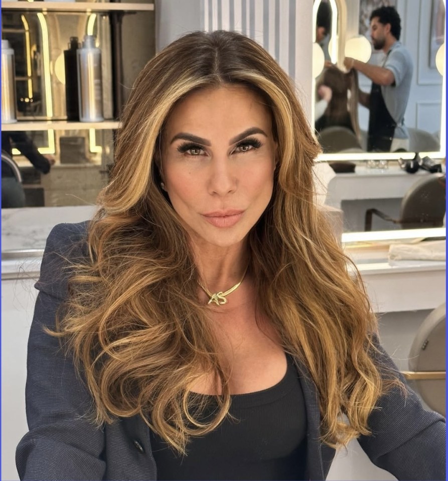 Andrea Sunshine, woman with long brown hair, wearing a black top and necklace.