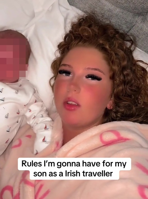 A young woman lies in bed with an infant, describing rules for her son.