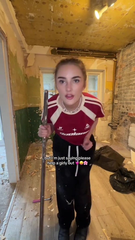 Woman in a damaged room asking for help with renovations.