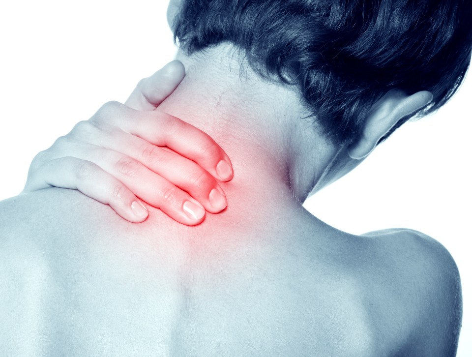 Woman holding her neck in pain.