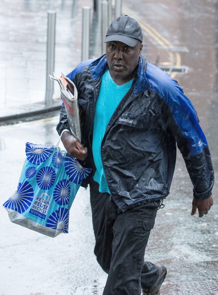Akinwale Arobieke leaving Manchester Crown Court after being cleared of breaching a ban on touching men's muscles.