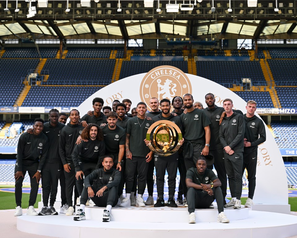 Chelsea football team posing with the Club World Cup trophy.