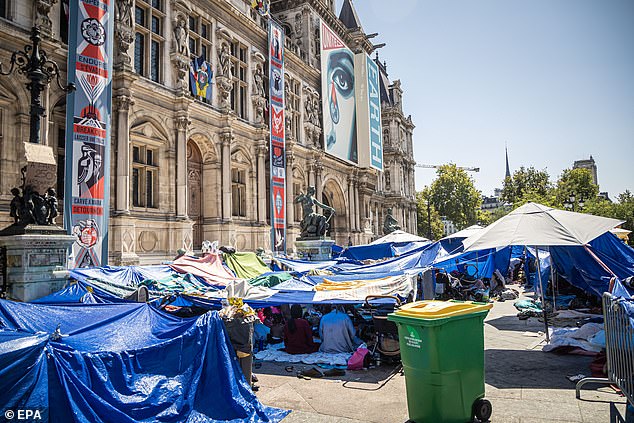 Migrants in a makeshift camp in front of the Paris City Hall wait for emergency accommodation in Paris, France, 11 August 2025