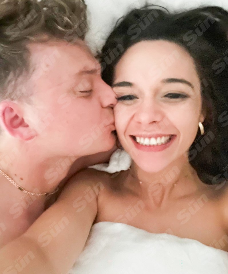Couple kissing in bed.