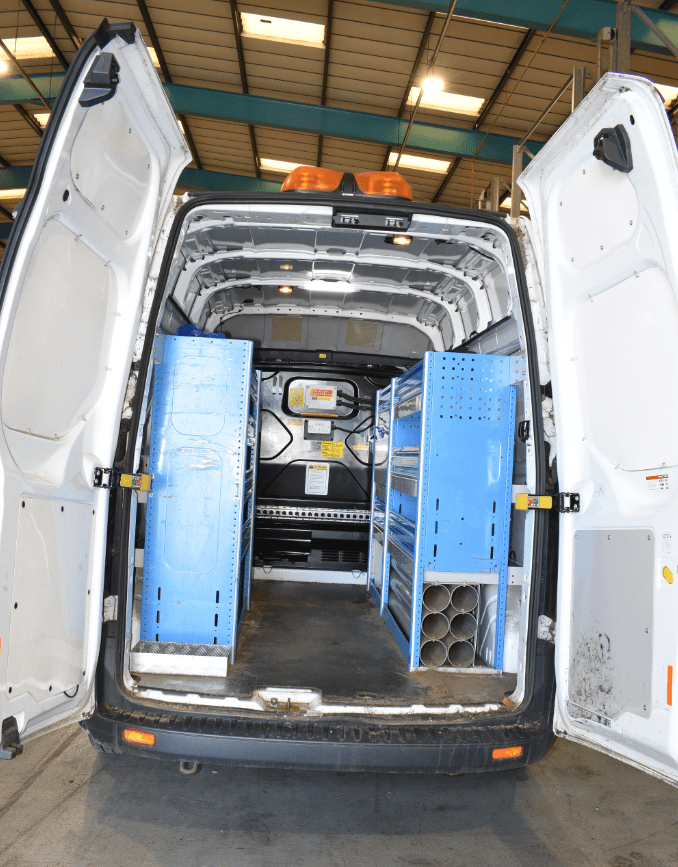 Rear interior of a white van used in a kidnapping, showing blue shelving units.