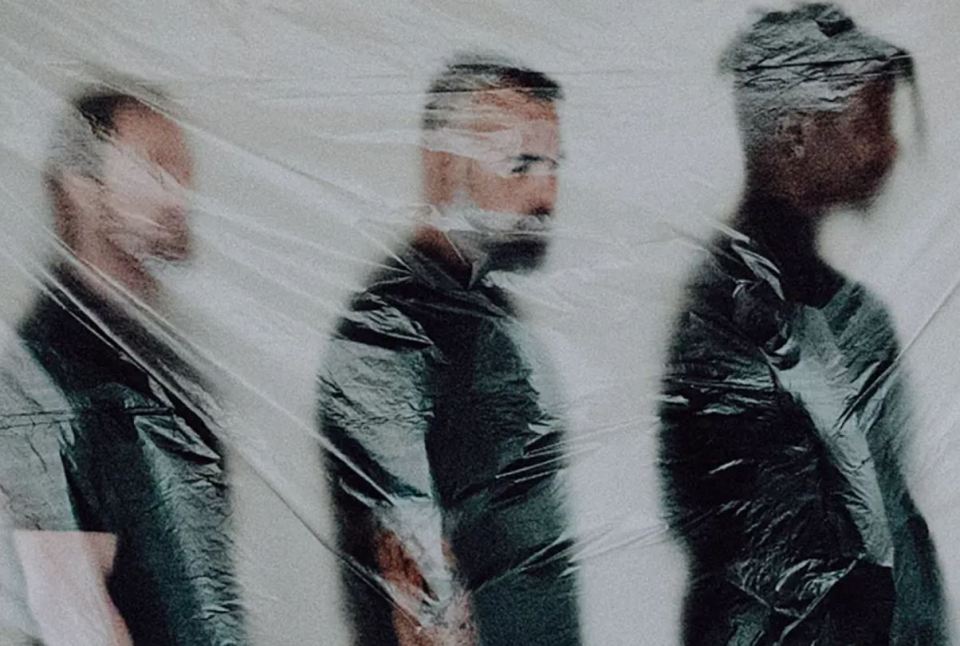 Three band members behind plastic wrap; Animals as Leaders cancel tour.