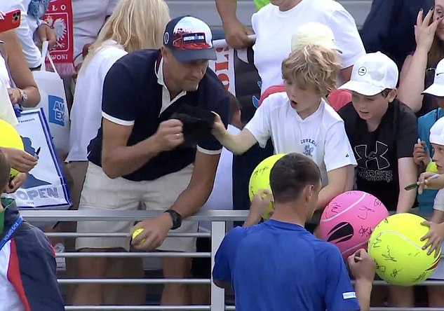 Footage shared online from the tennis US Open showed fans responding to the throw of a hat - with one man appearing to snatch a cap from the clasp of a young boy