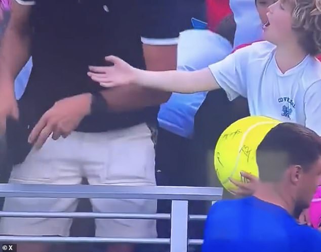 The disappointed young boy was seen asking 'what are you doing?' after the man took the cap