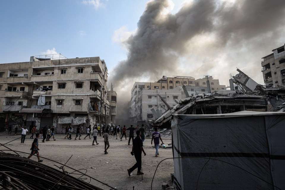 Smoke rises from damaged buildings in Gaza City after an Israeli airstrike.
