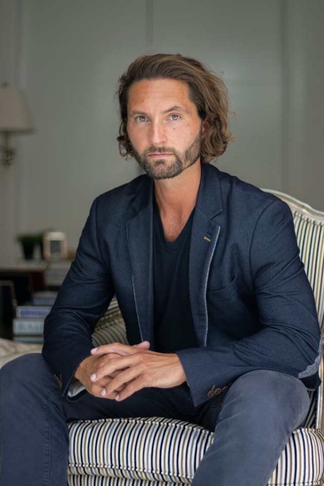 Portrait of a man sitting in a chair.