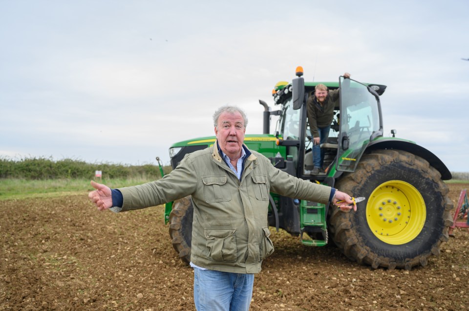 Jeremy Clarkson and Kaleb Cooper on a farm with a tractor.