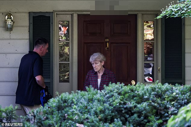 Cameras caught a glimpse of his distressed wife, Gretchen Smith Bolton, at the front door interacting with the federal agents on Friday morning