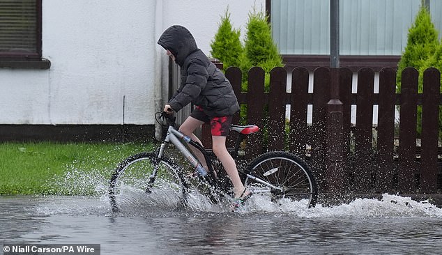 Parts of Britain and Ireland are to be battered by the storm. Pictured: A cyclist riding through flood water on the Bay Estate in Dundalk, Co Louth, last week