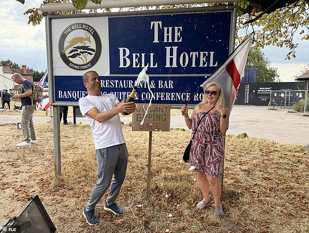 Protesters open bottles of Prosecco outside The Bell Hotel on Tuesday after it was announced it would be closing