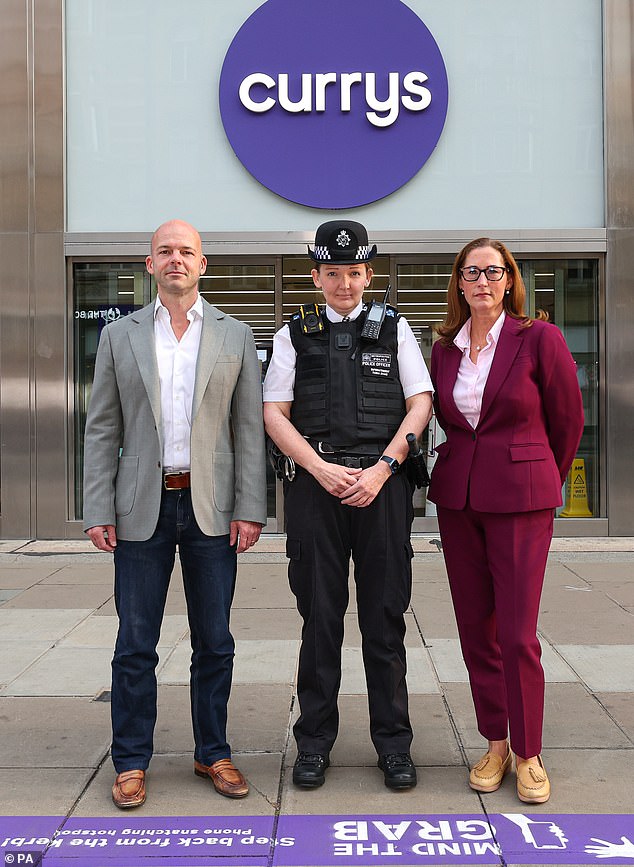 Ed Connolly, Chief Commercial Officer, Currys, Superintendent Natasha Evans, Metropolitan Police, Westminster, and Kate Johnston, Director, Crimestoppers, standing in front of the purple line