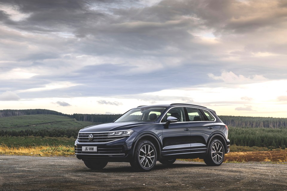 Volkswagen Touareg parked on a gravel road.