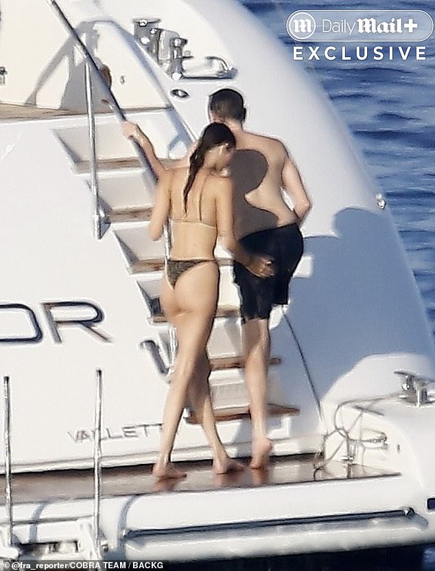 In one snap, she was seen lovingly spanking his buttocks