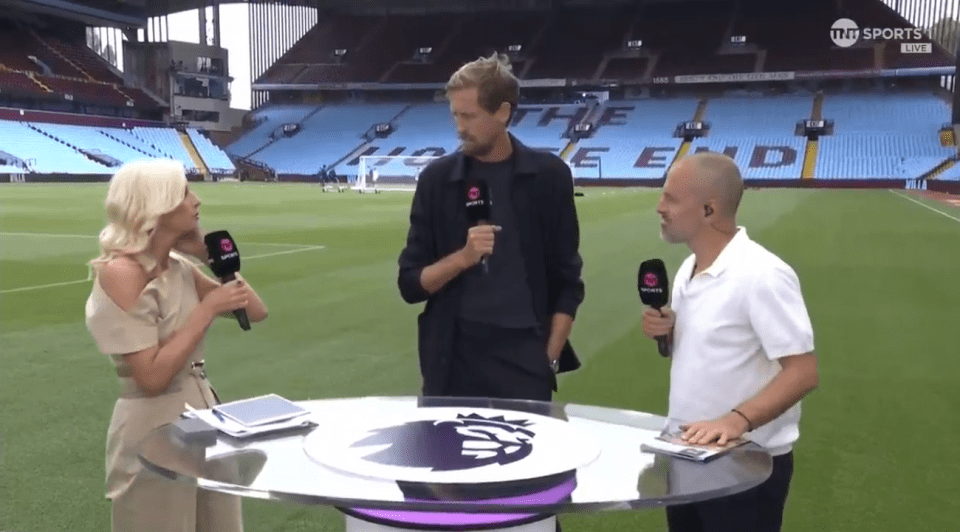 Three sportscasters interviewing each other at a stadium.