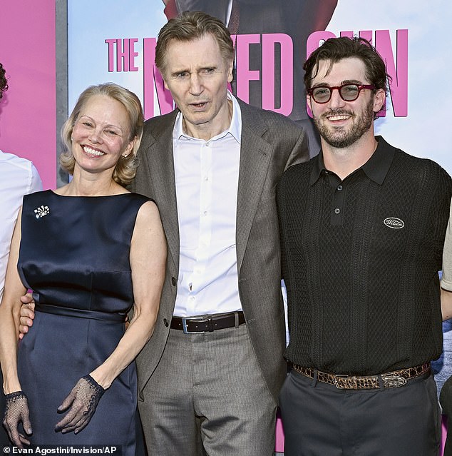 Liam Neeson's (M, pictured last Monday) son Daniel Jack Neeson (R) reacted to his surprising romance with his Naked Gun leading lady Pamela Anderson (L), by commenting on her Instagram post featuring the coy couple last Friday