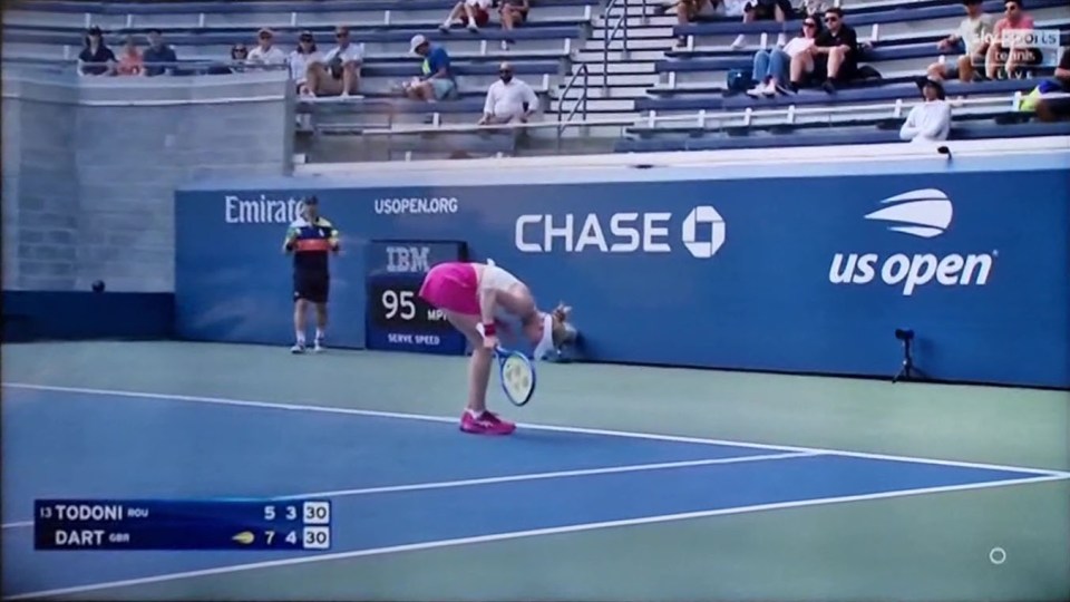 A tennis player bending over on a court at the US Open.