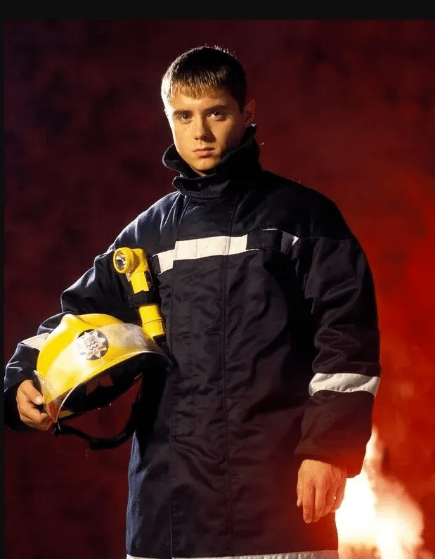 Firefighter holding helmet.