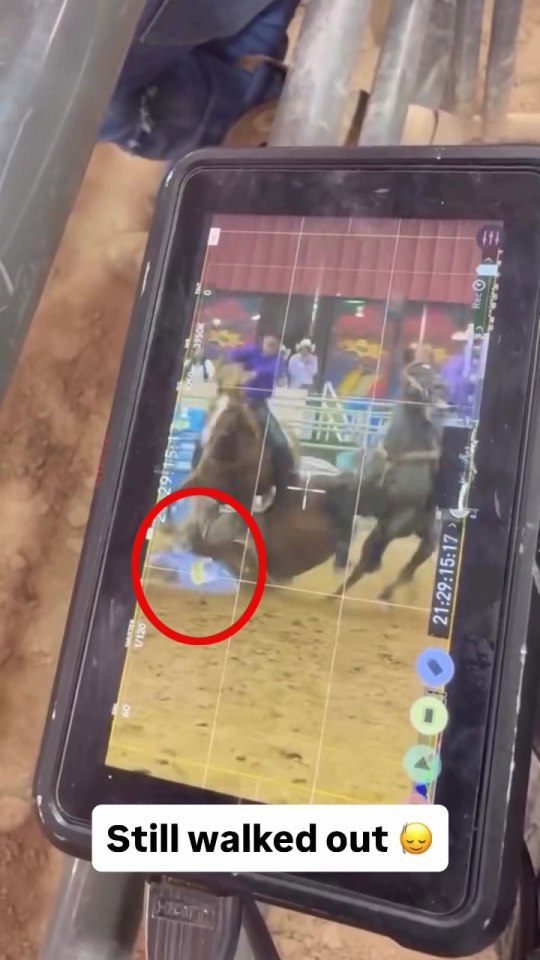 Tablet screen showing a rodeo rider falling off a horse.