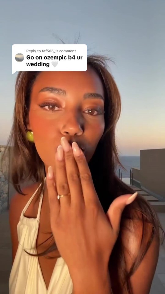 Woman blowing a kiss and responding to a comment about Ozempic.