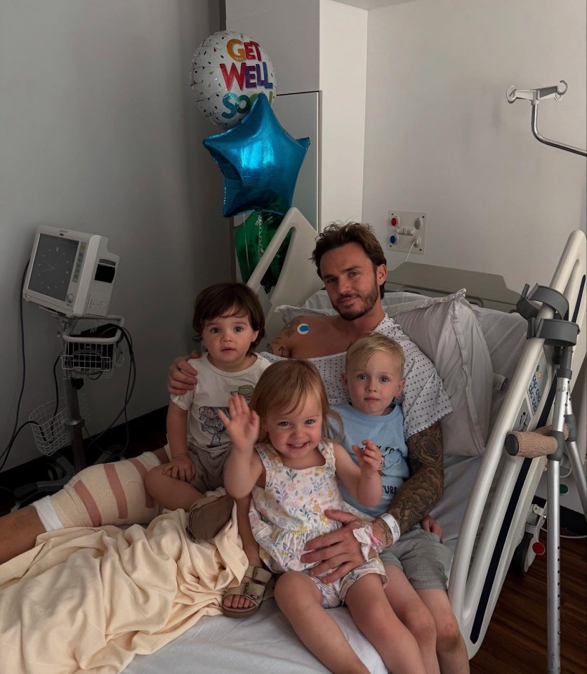Man in hospital bed with three young children and get well balloons.