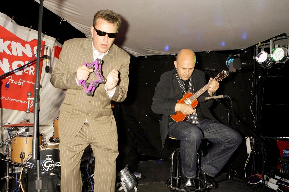 Suggs and Chris Foreman of Madness performing.