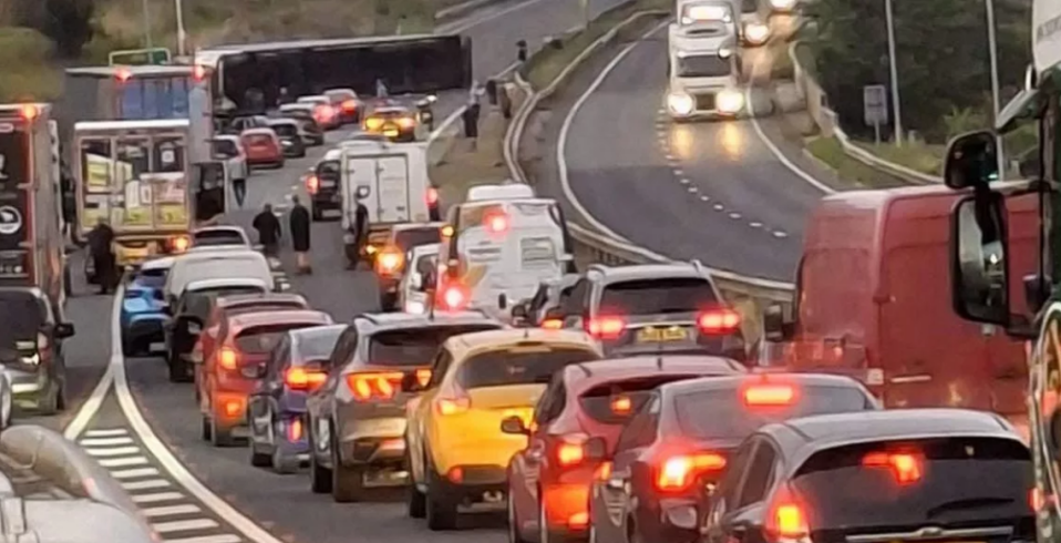 Traffic jam on a highway with an overturned bus.