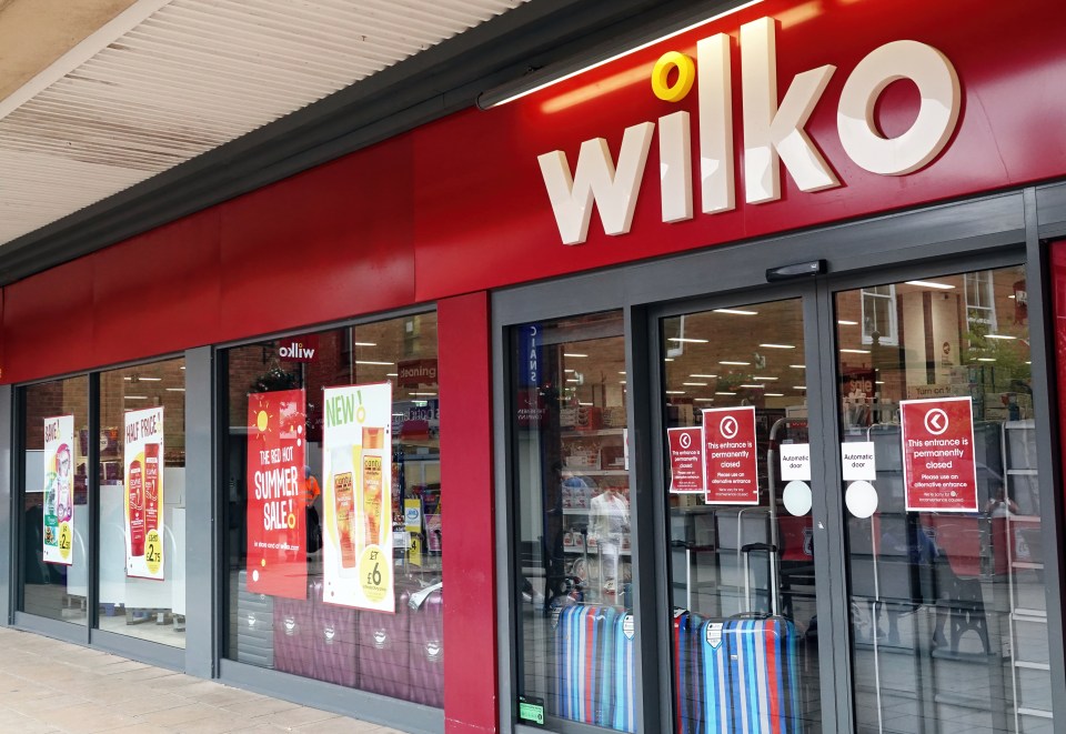 Wilko store exterior with signage indicating a summer sale and a permanently closed entrance.