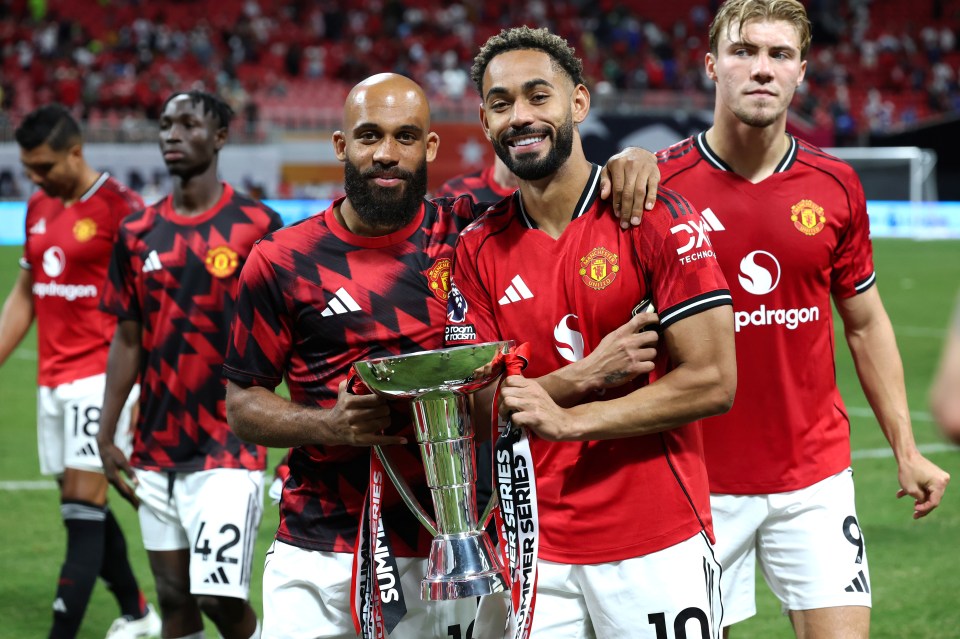 Manchester United players holding Premier League Summer Series trophy.