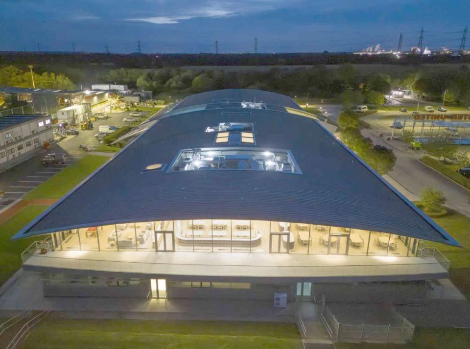 Aerial view of the refurbished Carrington Manchester United training ground at night.