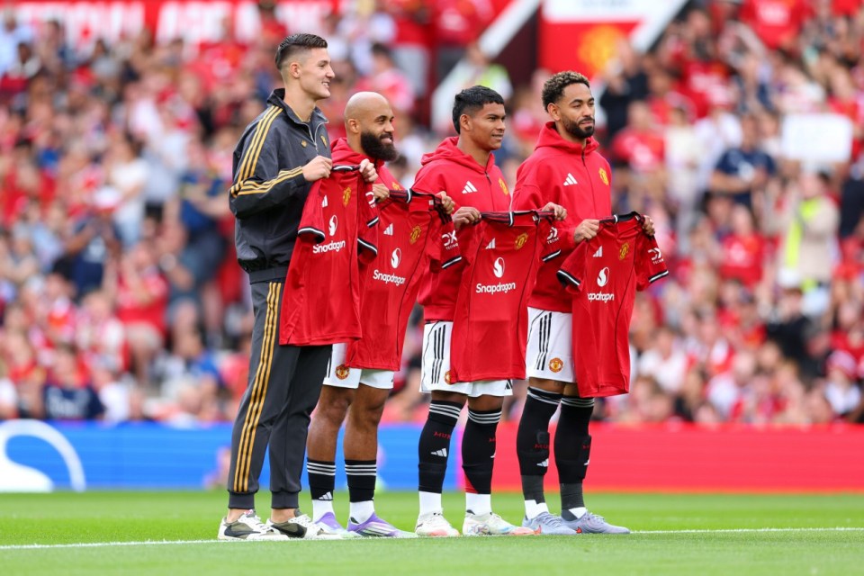 MANCHESTER, ENGLAND - AUGUST 09: New signings Bryan Mbeumo, Benjamin Sesko, Diego Leon and Matheus Cunha of Manchester United pose for a photo while holding match shirts prior to the pre-season friendly match between Manchester United and ACF Fiorentina at Old Trafford on August 09, 2025 in Manchester, England. (Photo by Molly Darlington/Getty Images)