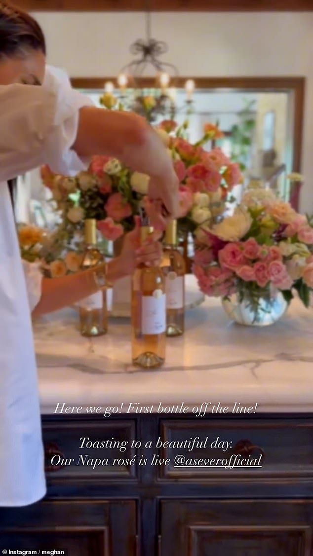 Meghan was seen uncorking a wine bottle marked 'Bottle #1' in front of bouquets of flowers as she launched her latest wine earlier this month