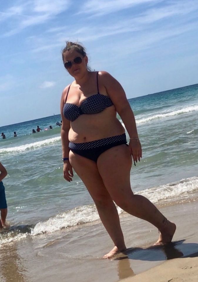 Woman in a polka dot bikini at the beach.