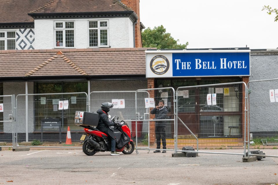 A delivery driver on a scooter outside The Bell Hotel in Epping Forest.