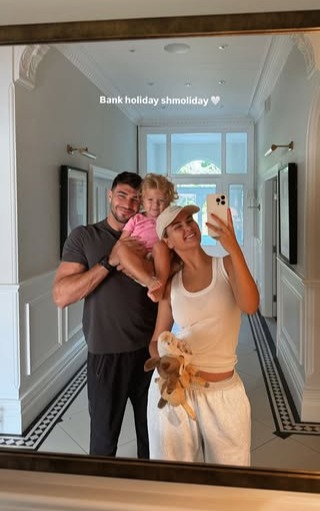 Family selfie in a hallway mirror.