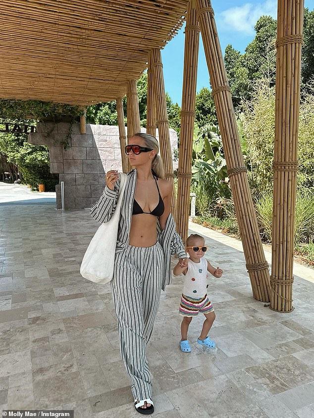 Molly looked lovely in a striped co-ord and bikini as she walked along with Bambi