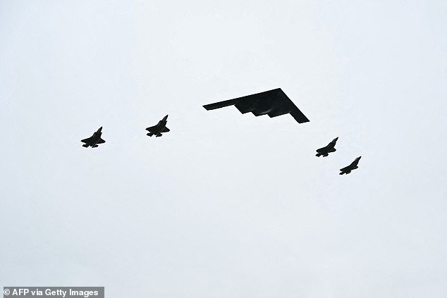 As the two leaders walked across the tarmac at Elmendorf Air Force Base in Anchorage, the US president surprised Putin with a military flyover of a US BS B2 stealth bomber and four F-35s (pictured)