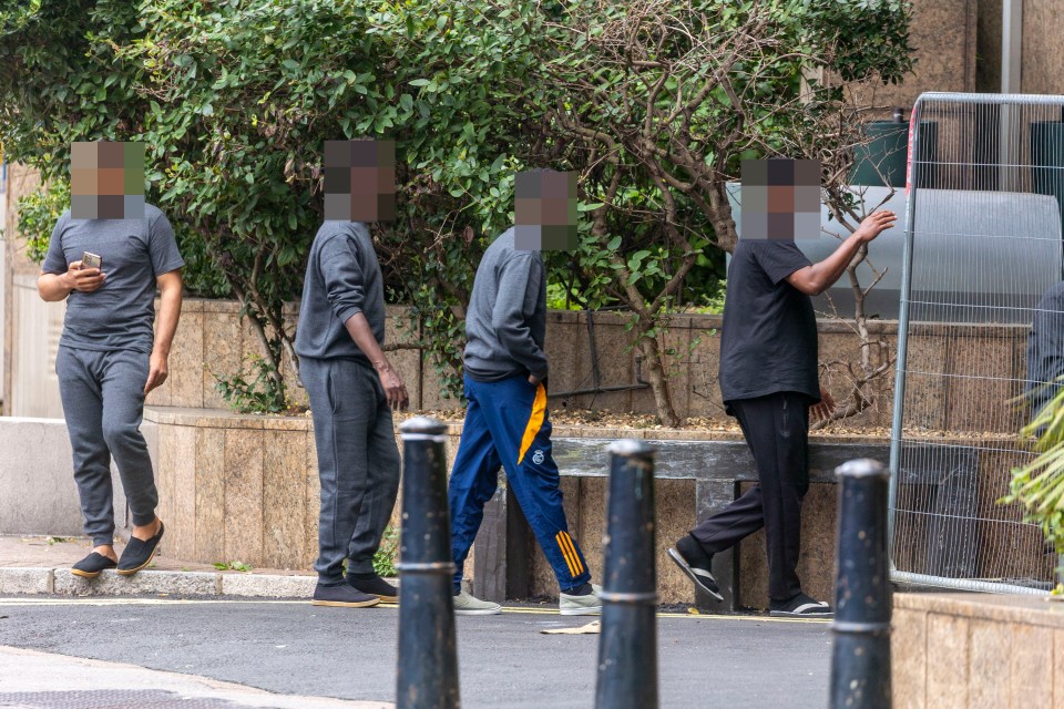 Group of migrants outside a hotel in London.
