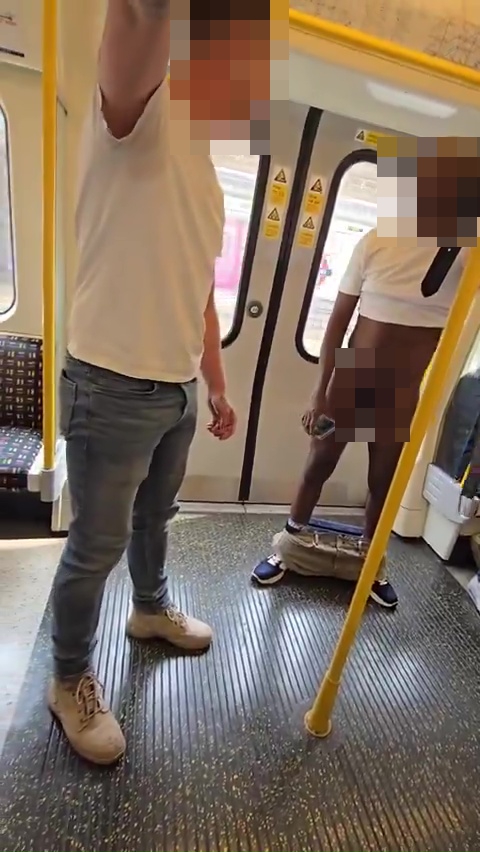 A naked man being restrained by another man on a subway.