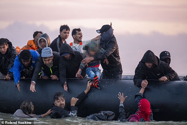 This is the moment (pictured) a small boat arrived at Gravelines beach to pick up migrants to take them illegally across to the UK