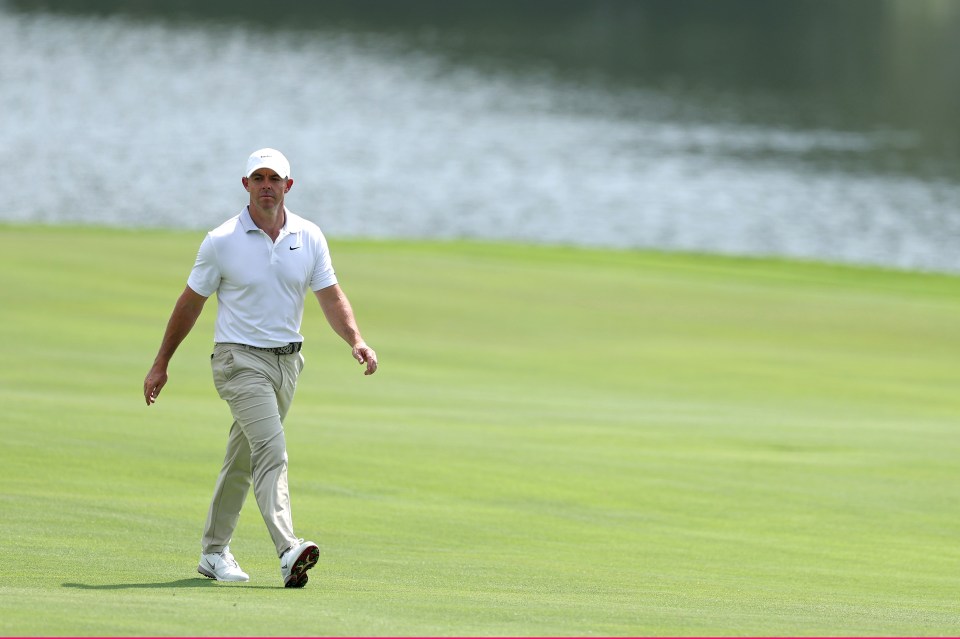 Rory McIlroy walking on a golf course.