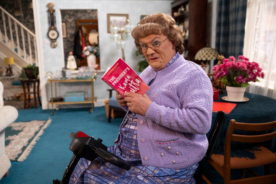 Agnes Brown on a mobility scooter reading "The President's Kama Sutra."