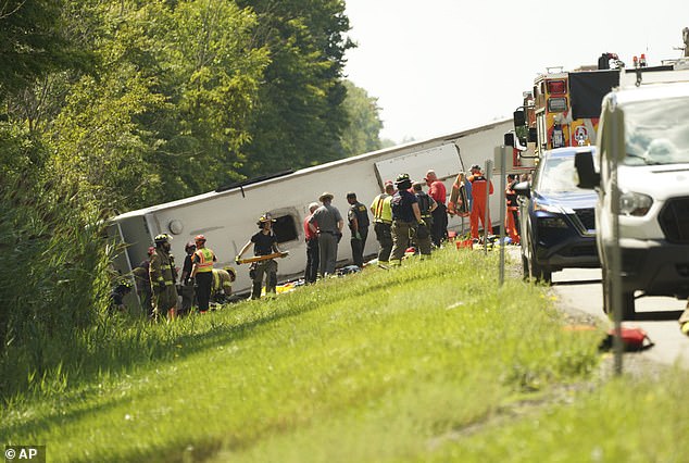 First responders work to rescue victims at the scene of a tour bus that crashed and rolled over on the New York State Thruway