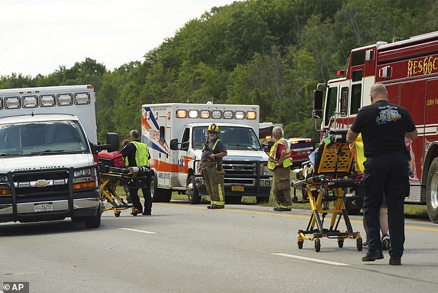 Emergency personnel with stretchers rush to the scene of the accident to help the 52 tour bus crash victims, many of whom were injured or trapped, along I-90 near Pembroke, NY