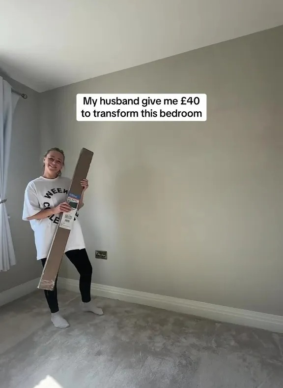 Woman holding a long package in a bedroom, ready to start a £40 makeover.